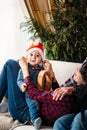 Christmas family portrait of happy smiling little boy in red santa hat in mother`s hands. Winter holiday Xmas and New Year Royalty Free Stock Photo