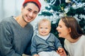 Portrait of friendly family looking at camera on Christmas evening