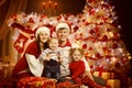 Christmas Family Portrait in Xmas Tree Interior Lights, New Year Royalty Free Stock Photo