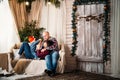 Christmas family portrait of young happy smiling parents playing with small kid in red santa hat. Winter holiday Xmas and New Year Royalty Free Stock Photo