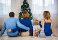 Christmas with family. Rear view of parents, little son, daughter. Dressed in shades of blue Royalty Free Stock Photo