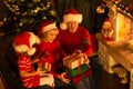 Christmas family in red hats with gift boxes Royalty Free Stock Photo