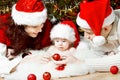 Christmas family in red hats giving gifts Royalty Free Stock Photo