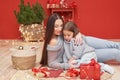 Christmas family. Red Merry Christmas tree background. Woman mother and child daughter celebrate new year. Xmas greeting card. Royalty Free Stock Photo