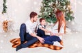 Christmas family smiling and kissing near the Xmas tree. Royalty Free Stock Photo