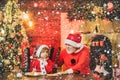 Christmas family in snow. Child write letter to Santa. Kid grandson and grandfather in Santa Hat Writing Wish List - Royalty Free Stock Photo