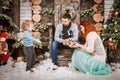 Christmas happy family of three persons and fir tree with gift boxes new year winter decorated background Royalty Free Stock Photo