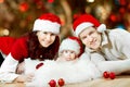 Christmas family of three persons in red hats Royalty Free Stock Photo
