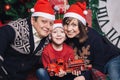 Christmas family of three persons in red hats Royalty Free Stock Photo