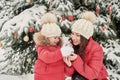 Christmas family in winter park. Happy family mother and child daughter having fun, playing at winter walk outdoors. Outdoor Royalty Free Stock Photo