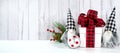 Christmas Farmhouse style background with red plaid bow gift and gnomes.