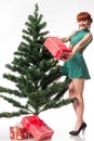 Christmas Fashion Woman with Gifts in Fir Tree Green Dress, Group of Beauty Models in Fantasy Xmas Holiday Gown Royalty Free Stock Photo