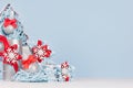 Christmas festive background for advertising and design - decorative red and blue fir tree with glittering balls and gift boxes. Royalty Free Stock Photo