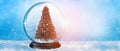 Christmas festive background. Winter snowy shiny  backdrop. Glass snow globe with Christmas tree Royalty Free Stock Photo