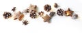 Christmas festive border, banner. Winter arrangement of pine cones, anise, wooden stars and glowing Christmas lights Royalty Free Stock Photo