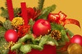 Christmas festive bouquet of fir branches, red and gold balls, apples and cones, red candles and ribbons Royalty Free Stock Photo