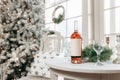 Christmas festive decoration with garlands, bottle wine, glasses, golden balls and fir tree. Royalty Free Stock Photo
