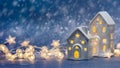 Christmas festive decorations on blue blurred background. illuminated toy houses and glowing garland lights Royalty Free Stock Photo