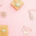 Christmas festive frame. Christmas gifts, decoration wooden toys and silver confetti on pink background. Flat lay, top view Royalty Free Stock Photo