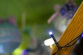 Christmas festive garland lamp light glare and rays on unfocused blurred colorful