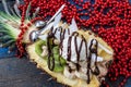 Christmas festive pineapple cut in half with a scoop of ice cream