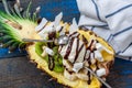 Christmas festive pineapple cut in half with a scoop of ice cream