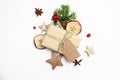 Christmas festive styled stock image composition. Handmade gift box with craft paper tag, berries, wooden stars, dried