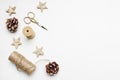 Christmas festive styled stock image composition. Pinecones, golden scissors, rope and wooden stars on white wooden
