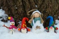 Christmas figures stand in one row. A snowman, an angel, and a few dwarfs Royalty Free Stock Photo
