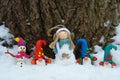 Christmas figures stand in one row. A snowman, an angel, and a few dwarfs Royalty Free Stock Photo