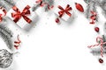 Christmas fir branches, gift boxes with red ribbon, red decoration, sparkles and confetti on white background. Xmas and New Year Royalty Free Stock Photo