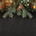 Christmas Fir branches with lights on dark black background. Xmas and Happy New Year card, bokeh, sparking, glowing. Royalty Free Stock Photo