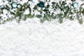 Christmas Fir Tree Border with Christmas Tree Baubles on Snow Royalty Free Stock Photo