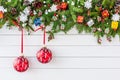 Christmas fir tree branch with decoration on white wooden board background. Top view, copy space. Royalty Free Stock Photo