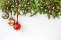 Christmas fir tree branch with decoration on white wooden board background. Top view, copy space Royalty Free Stock Photo