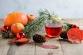 Christmas fir tree branch and herbal tea with toys, pumpkins, apples and autumn leaves Royalty Free Stock Photo