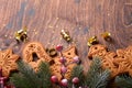 Christmas fir tree branches, Christmas balls, Christmas gingerbread, gift box, wooden snowflakes and stars on old wooden backgroun Royalty Free Stock Photo