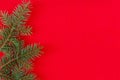Christmas fir tree branches on a red background fir branches border on red background, good for christmas backdrop Royalty Free Stock Photo