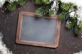 Christmas fir tree and chalkboard for your greetings Royalty Free Stock Photo
