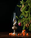 Christmas fir tree with cones decorated with multi-colored glass balls on a black background