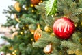 Christmas fir tree decorated with red and golden baubles with 2021 numbers. Bright festive holiday decoration. Blurred background. Royalty Free Stock Photo