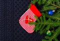 Christmas fir tree with decoration on dark blue knitted wool background Royalty Free Stock Photo