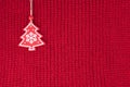 Christmas fir tree decoration on red wool knitted fabric Royalty Free Stock Photo