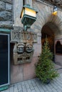 Christmas fir tree with lights garland and two soapstone trolls from Kalevala designed by Hilda Flodin on main entrance facade of