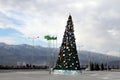 Christmas fir-tree on a square of Ashgabad and mountains as back
