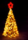 Christmas fir tree with star made of lights. Bokeh, blurred background. Holidays Royalty Free Stock Photo