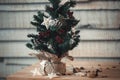 Christmas fir-tree on wooden background with light in star form for the design of a new year postcard. Flare copy space