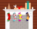 Christmas fireplace with hanging socks for gifts. Vector illustration.