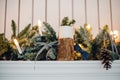 Christmas Fireplace, Xmas Lights Decoration, Tree Branches, candles and pine pieces Royalty Free Stock Photo