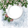 Christmas firtree with holly, snowfal and frame on wooden white